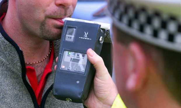 Man providing a breath sample at the roadside Road side breath test being performed